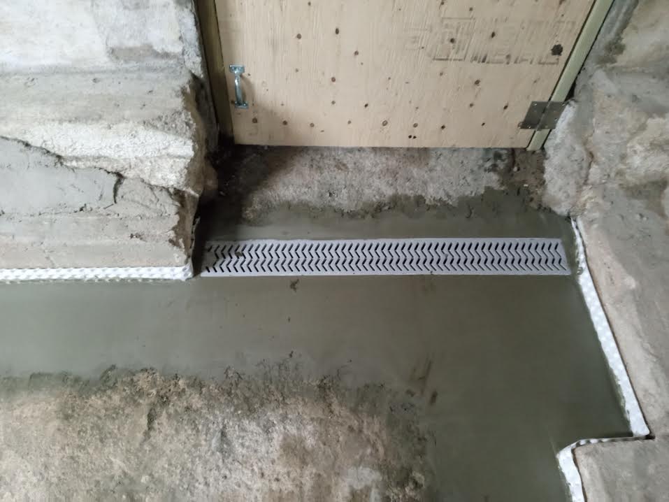 Footing drain with pipe and stone system